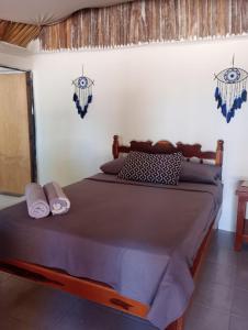 a bedroom with a bed with two towels on it at Cabañas El Cuyo in El Cuyo