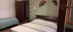 a bedroom with a bed in a room with a door at Casa di Cecco in Stazione di Laterina