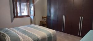 a bedroom with a bed and a cabinet and a window at Casa di Cecco in Stazione di Laterina