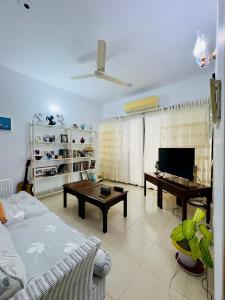 a living room with a couch and a table at Green House DHK in Dhaka