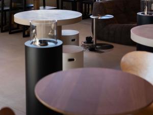 a room with two tables and a couch and chairs at Ibis Valencia Alfafar in Alfafar