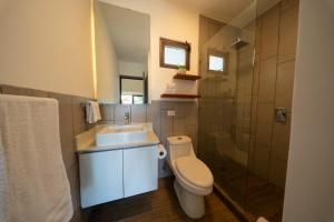 a bathroom with a toilet and a sink and a shower at Elegant Villa with Poolfront View in Monterrico +11 photos