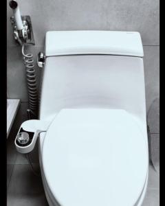 a toilet in a bathroom with the lid up at 1BR Condo near Tourist Spots in Baguio