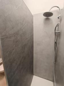 a shower in a bathroom with a wall at La Rosa di Orvieto in Orvieto