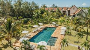 an aerial view of a resort pool with umbrellas at Crystals Beach Resort Belle Mare, a member of Radisson Individuals in Belle Mare