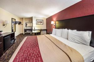 a hotel room with a large bed and a desk at Red Roof Inn Anderson, IN in Anderson +65 photos