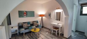 a living room with a couch and a table at Ragousis Apartments in Parikia