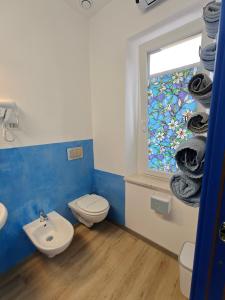 a bathroom with a toilet and a window with towels at La Rosa di Orvieto in Orvieto +56 photos