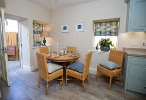 a dining room with a wooden table and chairs at Wilson House in St. Andrews
