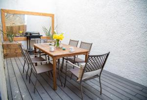 a wooden table and chairs on a deck at Wilson House in St. Andrews +7 photos