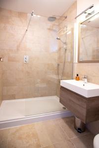 a bathroom with a tub and a sink and a shower at Wilson House in St. Andrews