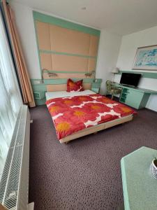 a bedroom with a large bed and a desk at la casa mia in Bad Langensalza