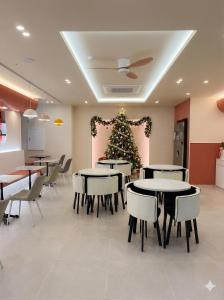 a dining room with tables and a christmas tree at Mi Stay - StarBnB branch in Daegu