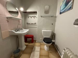 a bathroom with a sink and a toilet and a mirror at Belle de Nuit in Oppède