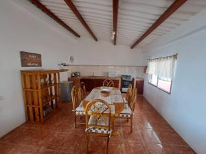 a kitchen with a table and chairs in a room at Villa Solara - A Beachfront Residence in San Clemente
