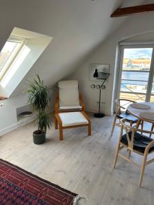 a living room with a chair and a table at Havnehuset Kerteminde in Kerteminde