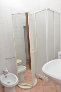 a bathroom with a shower and a toilet and a sink at Central apartment in Arluno
