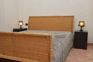 a bedroom with a bed and two lamps on night stands at Central apartment in Arluno