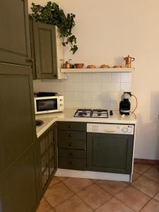 a kitchen with a stove and a microwave at Central apartment in Arluno