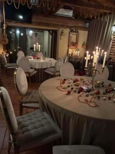 a dining room with a table and chairs and candles at CASA LUCA in Moldova Nouă