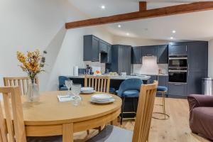 a kitchen and dining room with a wooden table and chairs at 2 Bed in Latton oc-c34099 in Clapton