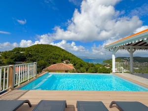 a swimming pool with a view of the ocean at Villa Altaïa - Sea View & Infinity Pool in Les Trois-Îlets