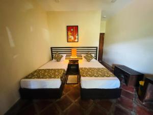 a room with two beds in a room at NILGIRA VILLA By LILYS in Badulla