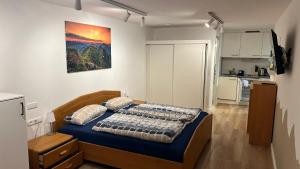 a bedroom with a bed with blue sheets and pillows at Mellau Appartments 220 in Mellau