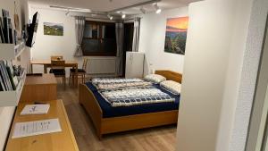 a small room with a bed and a dining room at Mellau Appartments 220 in Mellau