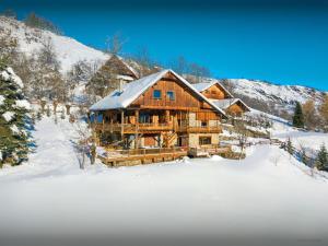 a large log cabin in the snow with snow at Chalet Bendo - OVO Network in Villarembert