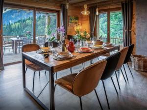 a wooden table with chairs and a dining room at Chalet Bendo - OVO Network in Villarembert +25 photos