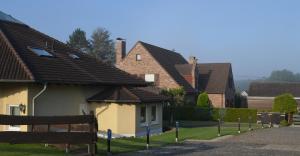 a row of houses with roofs on a street at Gästehaus Windhagen in Windhagen