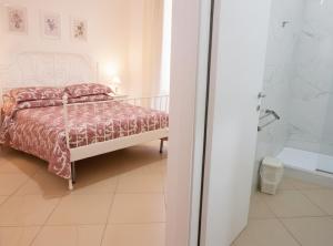 a bedroom with a bed and a walk in shower at La Locanda del Baffo in Capua +23 photos