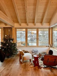 a living room with a christmas tree and a couch at La Tzoumaz Lodge in La Tzoumaz