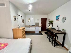 a bedroom with a bed and a desk and a kitchen at Le Cocon 54 Studio à Rives Parking facile in Rives