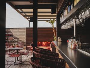 a bar with chairs and a counter with wine glasses at Catalonia Molina Lario in Málaga