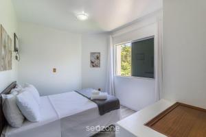 a white bedroom with a bed and a window at 1-Bedroom Apt in Blumenau SPN0102 in Blumenau +15 photos