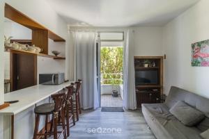 a kitchen and living room with a couch and a table at 1-Bedroom Apt in Blumenau SPN0102 in Blumenau