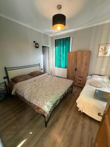 a bedroom with two beds and a window at Green Villa Tsaghveri in Tsaghveri