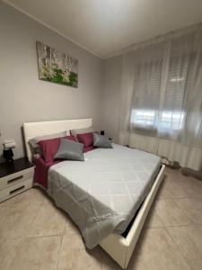 a bedroom with a large bed and a window at Casa Debby in Serravalle Scrivia