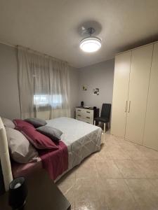 a bedroom with a bed and a desk in it at Casa Debby in Serravalle Scrivia +2 photos