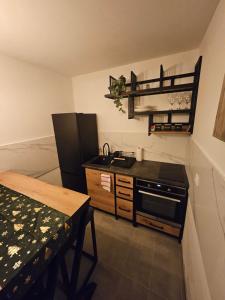a small kitchen with a sink and a stove at Mali Princip in Pale