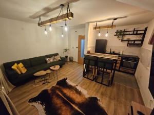 a living room with a green couch and a table at Mali Princip in Pale