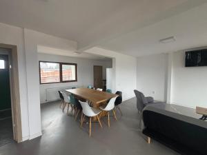 a room with a table and chairs and a bed at Cabana Lake View in Bălceşti