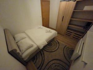 a small bed in a room next to a door at Mali Princip in Pale