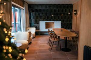 a room with a table and chairs and a couch at MontiSio Boutique Hotel in Gudauri