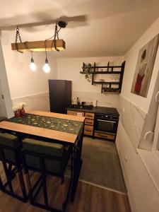 a kitchen with a table and a stove in it at Mali Princip in Pale +2 photos