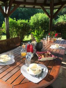 a wooden table with food on top of it at Chambres d'hôtes Maison Efftermatten in Andlau