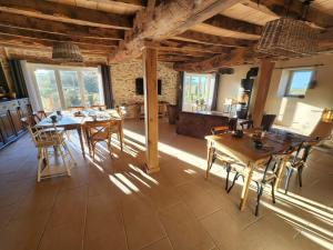 a dining room with wooden tables and chairs at La Source Du Bonheur Chambres et Table d'Hôtes in Rieupeyroux