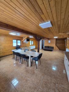 a large dining room with a table and chairs at Cabana Soarelui - Valisoara in Vălişoara